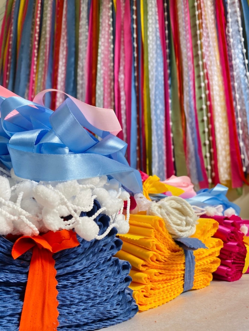 Colorful ribbons and yarn bundles with a blurred multicolored background
