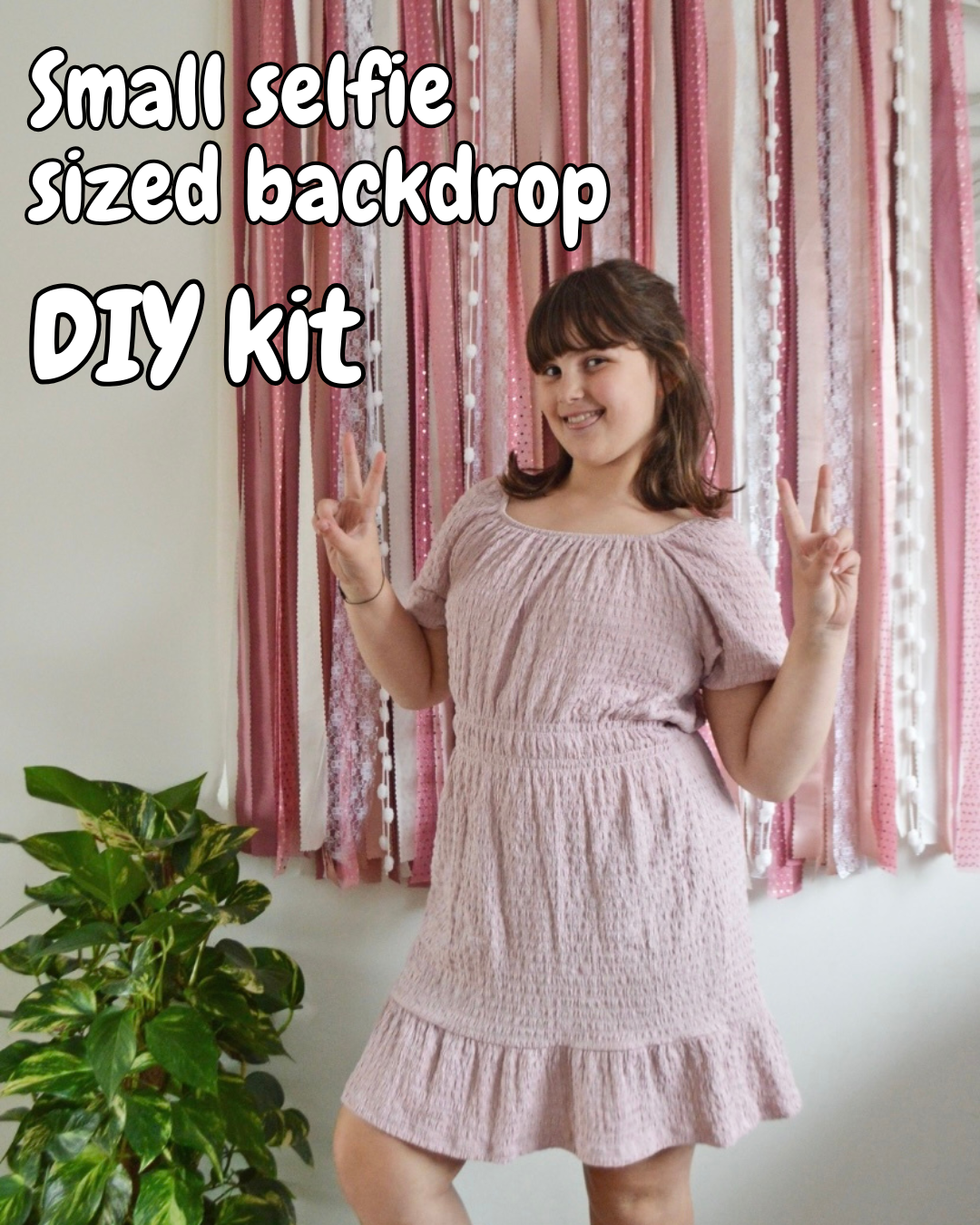 Girl posing in front of ribbon backdrop DIY kit