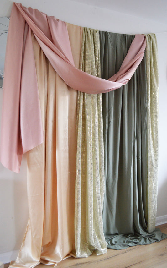pastel coloured fabric draped to create an elegant backdrop.