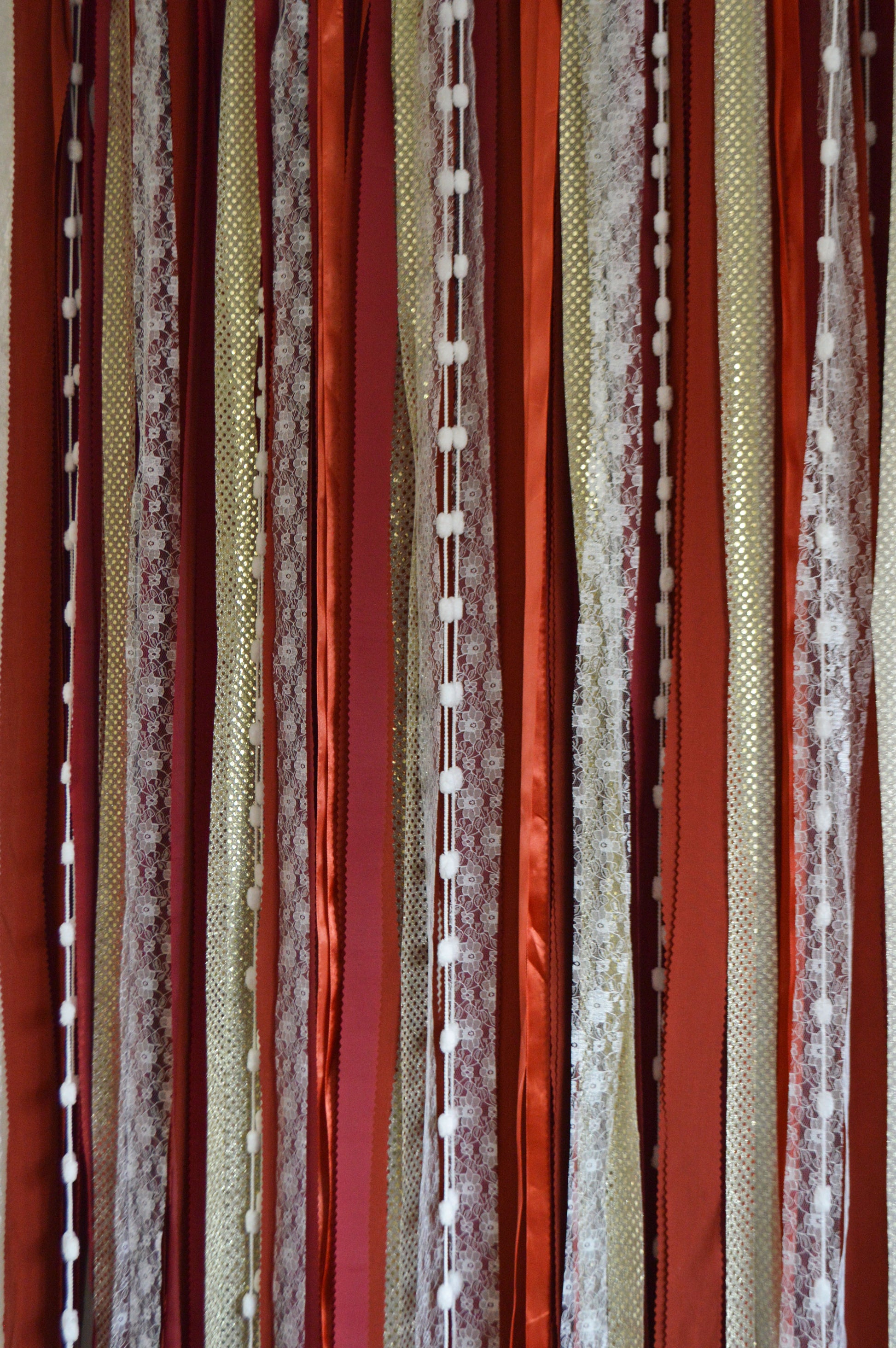 Striped fabric backdrop with red, brown, and beige colors